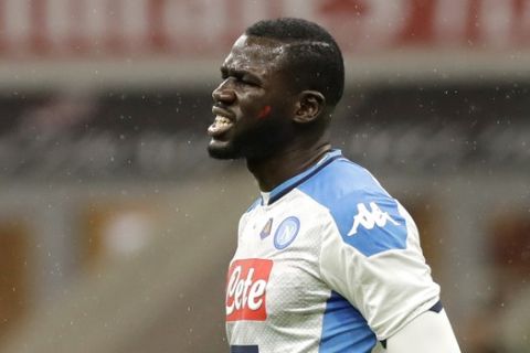 Napoli's Kalidou Koulibaly grimaces during a Serie A soccer match between AC Milan and Napoli, at the San Siro stadium in Milan, Italy, Saturday, Nov. 23, 2019. (AP Photo/Luca Bruno)