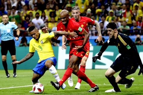 Brazil's Gabriel Jesus, left shields the ball from Belgium's Vincent Kompany centre and Belgium goalkeeper Thibaut Courtois during the quarterfinal match between Brazil and Belgium at the 2018 soccer World Cup in the Kazan Arena, in Kazan, Russia, Friday, July 6, 2018. (AP Photo/Matthias Schrader)