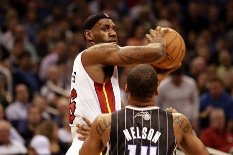 ORLANDO, FL - FEBRUARY 03:  Forward LeBron James #6 of the Miami Heat looks over guard Jamee Nelson #14 of the Orlando Magic at Amway Arena on February 3, 2011 in Orlando, Florida. NOTE TO USER: User expressly acknowledges and agrees that, by downloading and or using this photograph, User is consenting to the terms and conditions of the Getty Images License Agreement. (Photo by Marc Serota/Getty Images)