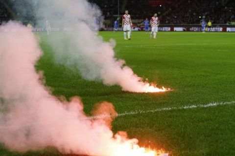 Flares thrown by supporters burn on the field of play during the Euro 2016 qualifying soccer match between Italy and Croatia, at the San Siro stadium in Milan, Italy, Sunday, Nov. 16, 2014. (AP Photo/Antonio Calanni) Italy Croatia Euro Soccer