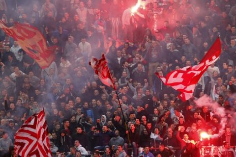 Red Star soccer fans light torches during a Serbian National soccer league derby match between Red Star and Partizan in Belgrade, Serbia, Tuesday, April 18, 2017. (AP Photo/Darko Vojinovic)