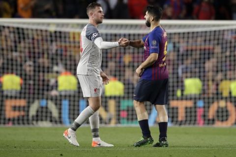 Liverpool's Jordan Henderson, left, and Barcelona's Luis Suarez greet each others at the end of the Champions League semifinal, first leg, soccer match between FC Barcelona and Liverpool at the Camp Nou stadium in Barcelona, Spain, Wednesday, May 1, 2019. (AP Photo/Emilio Morenatti)