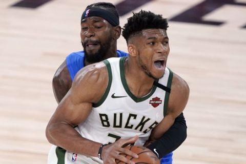 Orlando Magic's Terrence Ross, rear, defends against Milwaukee Bucks' Giannis Antetokounmpo during the first half of an NBA basketball first round playoff game Saturday, Aug. 29, 2020, in Lake Buena Vista, Fla. (AP Photo/Ashley Landis)