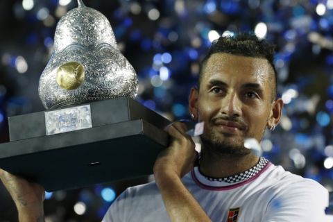 Australia's Nick Kyrgios holds up his trophy as confetti falls, after winning his Mexican Tennis Open final match against Germany's Alexander Zverev, in Acapulco, Mexico, Saturday, March 2, 2019. (AP Photo/Rebecca Blackwell)