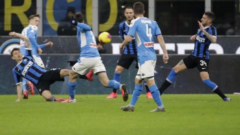 Napoli's Fabian Ruiz, third from left, scores his side's first goal during an Italian Cup soccer match between Inter Milan and Napoli at the San Siro stadium, in Milan, Italy, Wednesday, Feb. 12, 2020. (AP Photo/Luca Bruno)