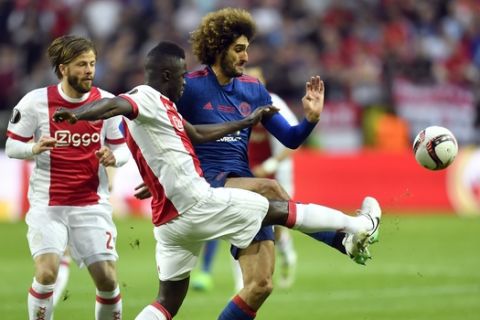 Ajax's Davinson Sanchez vies for the ball with United's Marouane Fellaini, right, during the soccer Europa League final between Ajax Amsterdam and Manchester United at the Friends Arena in Stockholm, Sweden, Wednesday, May 24, 2017. (AP Photo/Martin Meissner)