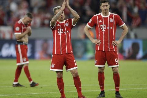 Bayern's Franck Ribery, Rafinha and Robert Lewandowski, from left, look disappointed after losing 1-2 during the semifinal first leg soccer match between FC Bayern Munich and Real Madrid at the Allianz Arena stadium in Munich, Germany, Wednesday, April 25, 2018. (AP Photo/Matthias Schrader)