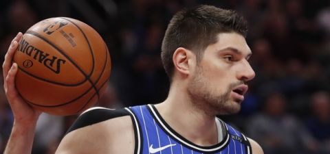 Orlando Magic center Nikola Vucevic passes during the first half of an NBA basketball game against the Detroit Pistons, Thursday, March 28, 2019, in Detroit. (AP Photo/Carlos Osorio)