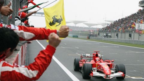 Ferrari team members celebrate as Michael Schumacher of Germany crosses the finish line to win the Chinese Grand Prix at the Shanghai International Circuit, Sunday, Oct. 1, 2006. Schumacher won the Grand Prix to tie Renault's Fernando Alonso in the race for the season driver's championship. (AP Photo/Claro Cortes IV, Pool)
