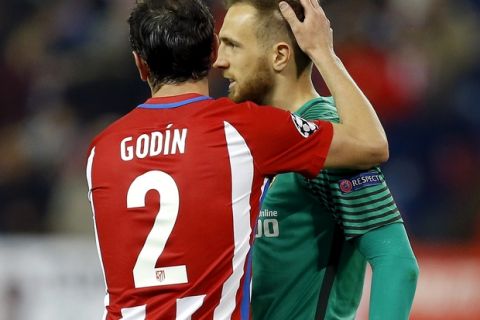 Atletico's Diego Godin, left, embraces Atletico goalkeeper Jan Oblak, right, after the Champions League round of 16 second leg soccer match between Atletico Madrid and Bayer 04 Leverkusen in Madrid, Spain, Wednesday, March 15, 2017. The match ended in a 0-0 draw. (AP Photo/Francisco Seco)