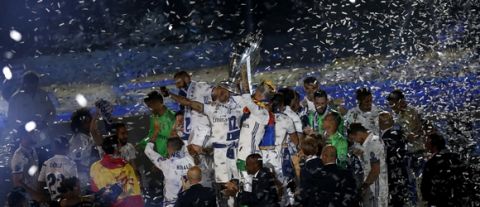 Real Madrid players celebrate with their trophy after winning the Champions League final, at the Santiago Bernabeu stadium in Madrid, Spain, Sunday, June 4, 2017. Real Madrid became the first team in the Champions League era to win back-to-back titles with their 4-1 victory over Juventus in Cardiff, Wales, on Saturday. (AP Photo/Francisco Seco)