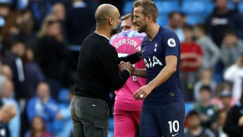Manchester City's head coach Pep Guardiola, left, shakes hands with Tottenham's Harry Kane at the end of the English Premier League soccer match between Manchester City and Tottenham Hotspur at Etihad stadium in Manchester, England, Saturday, Aug. 17, 2019. (AP Photo/Rui Vieira)