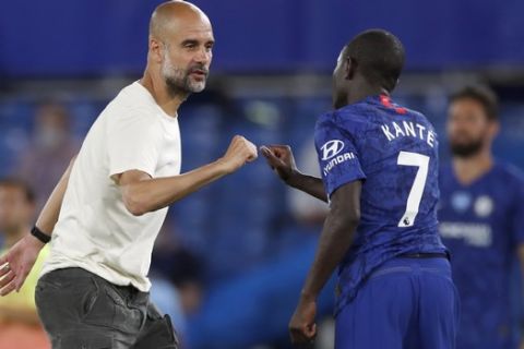 Manchester City's head coach Pep Guardiola, left, congratulates Chelsea's N'Golo Kante following their English Premier League soccer match between Chelsea and Manchester City at Stamford Bridge, in London, England, Thursday, June 25, 2020. (AP Photo/Paul Childs,Pool)