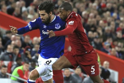Everton midfielder Andre Gomes, left, and Liverpool midfielder Georginio Wijnaldum compete for the ball during the English Premier League soccer match between Liverpool and Everton at Anfield Stadium in Liverpool, England, Sunday, Dec. 2, 2018. (AP Photo/Jon Super)