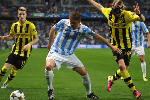 MALAGA, SPAIN - APRIL 03:  Marcel Schmelzer of Dortmund challenges for the ball with Joaquín of Malaga during the UEFA Champion League quarter final first leg match between Malaga CF and Borussia Dortmund at La Rosaleda Stadium on April 3, 2013 in Malaga, Spain.  (Photo by Stuart Franklin/Bongarts/Getty Images)