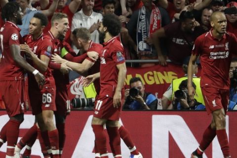 Liverpool's Divock Origi, left, celebrates with his teammates after scoring his side's second goal during the Champions League final soccer match between Tottenham Hotspur and Liverpool at the Wanda Metropolitano Stadium in Madrid, Saturday, June 1, 2019. (AP Photo/Felipe Dana)