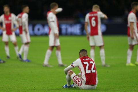 Ajax players with Hakim Ziyech, front, react to their elimination from the Champions League after losing the group H soccer match between Ajax and Valencia at the Johan Cruyff ArenA in Amsterdam, Netherlands, Tuesday, Dec. 10, 2019. (AP Photo/Peter Dejong)