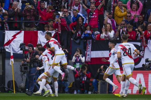 Rayo Vallecano players celebrate after Rayo's Raul de Tomas scored his side's opening goal during the Spanish La Liga soccer match between Rayo Vallecano and Real Madrid at the Vallecas stadium in Madrid, Spain, Sunday, Feb. 18, 2024. (AP Photo/Manu Fernandez)