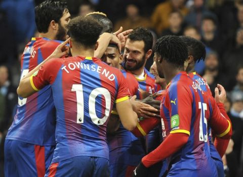 Crystal Palace players celebrate after Crystal Palace's Luka Milivojevic scored his side's third goal during the English Premier League soccer match between Manchester City and Crystal Palace at Etihad stadium in Manchester, England, Saturday, Dec. 22, 2018. (AP Photo/Rui Vieira)