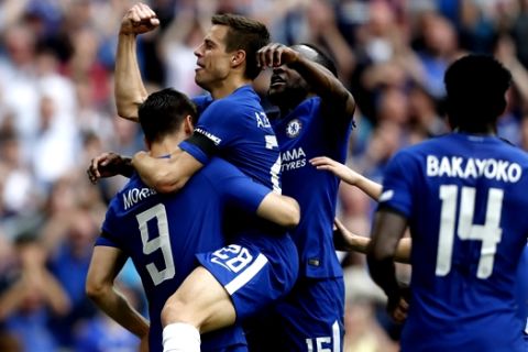 Chelsea's Alvaro Morata, left, celebrates with his teammates Cesar Azpilicueta and Victor Moses, after scoring his side second goal during the English FA Cup semifinal soccer match between Chelsea and Southampton at the Wembley stadium in London, Sunday, April 22, 2018. (AP Photo/Frank Augstein)