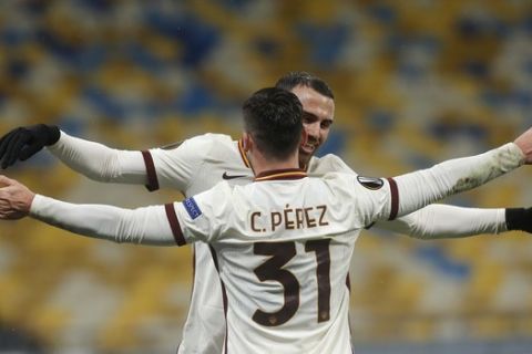 Roma's Borja Mayoral celebrates with Roma's Carles Perez after scoring his side's second goal during the Europa League round of 16 second leg soccer match between Shakhtar Donetsk and Roma at the Olimpiyskiy Stadium in Kyiv, Ukraine, Thursday, March 18, 2021. (AP Photo/Efrem Lukatsky)