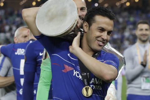 Chelsea's Pedro Rodriguez celebrates with the trophy after winning the Europa League Final soccer match between Arsenal and Chelsea at the Olympic stadium in Baku, Azerbaijan, Wednesday, May 29, 2019. Chelsea won 4-1. (AP Photo/Luca Bruno)