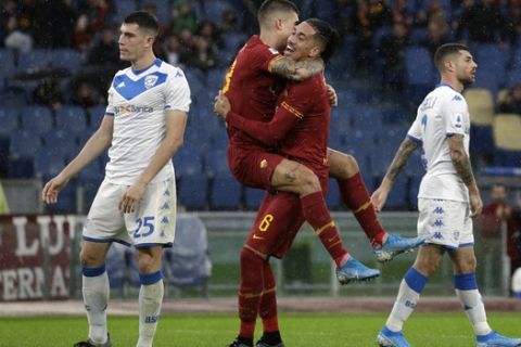 Roma's Chris Smalling, number 6, celebrates with his teammate Roma's Gianluca Mancini after scoring his side's opening goalduring the Serie A soccer match between Roma and Brescia at the Rome Olympic Stadium, Sunday, Nov. 24, 2019. (AP Photo/Andrew Medichini)
