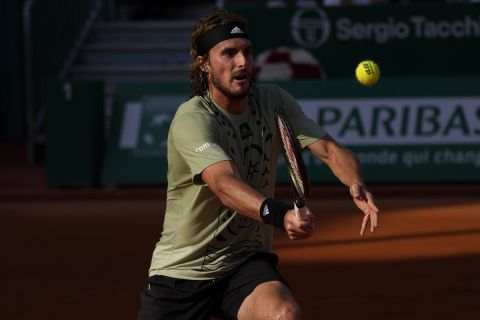 Stefanos Tsitsipas of Greece, returns the ball to Alexander Zverev, of Germany, during their semifinal match of the Monte-Carlo Masters tennis tournament, Saturday, April 16, 2022 in Monaco. (AP Photo/Daniel Cole)