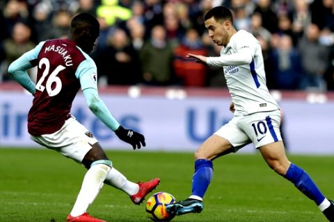 Chelsea's Eden Hazard, right, is challenged by West Ham United's Arthur Masuaku during the English Premier League soccer match between West Ham United and Chelsea at the London stadium in London, Saturday, Dec. 9, 2017. (AP Photo/Alastair Grant)