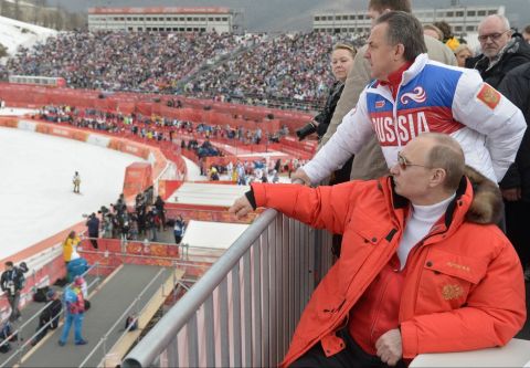 FILE - In this file photo taken Saturday, March 8, 2014, Russian President Vladimir Putin, foreground, watches downhill ski competition of the 2014 Winter Paralympics in Roza Khutor mountain district of Sochi, Russia, as Russia's sports minister Vitaly Mutko stands behind. On Monday, July 18, 2016 WADA investigator Richard McLaren confirmed claims of state-run doping in Russia. (AP Photo/RIA-Novosti, Alexei Nikolsky, Presidential Press Service)