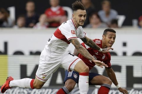 Stuttgart's Anastasios Donis, left, and Bayern's Thiago challenge for the ball during a German Bundesliga soccer match between VfB Stuttgart and Bayern Munich in Stuttgart, Germany, Saturday, Sept. 1, 2018. (AP Photo/Michael Probst)