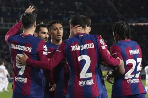 Barcelona's Joao Cancelo, center, celebrates with his teammates after scoring his side's second goal during the Champions League, round of 16, second leg soccer match between Barcelona and SSC Napoli at the Olympic Lluis Companys stadium in Barcelona, Spain, Tuesday, March 12, 2024. (AP Photo/Emilio Morenatti)