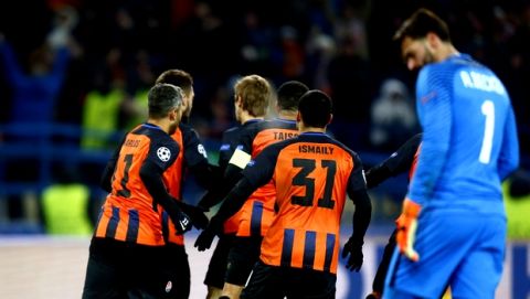 Shakhtar's Facundo Ferreyra celebrates with his teammates after scoring his side's opening goal during the Champions League, round of 16, first-leg soccer match between Shakhtar Donetsk and Roma at the Metalist Stadium in Kharkiv, Ukraine, Wednesday, Feb. 21, 2018. (AP Photo/Efrem Lukatsky)
