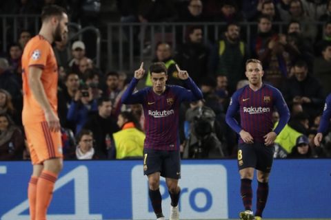 Barcelona's Philippe Coutinho, centre, celebrates after scoring his side's second goal during the Champions League round of 16, 2nd leg, soccer match between FC Barcelona and Olympique Lyon at the Camp Nou stadium in Barcelona, Spain, Wednesday, March 13, 2019. (AP Photo/Emilio Morenatti)