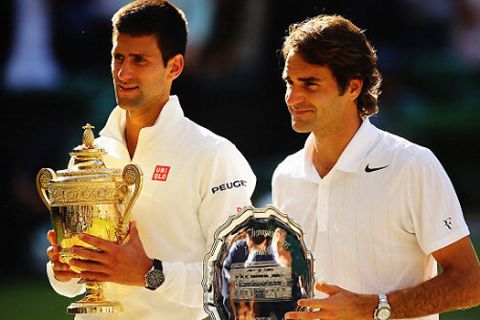 LONDON, ENGLAND - JULY 06:  Novak Djokovic of Serbia poses with the Gentlemen's Singles Trophy next to Roger Federer of Switzerland following his victory in the Gentlemen's Singles Final match on day thirteen of the Wimbledon Lawn Tennis Championships at the All England Lawn Tennis and Croquet Club on July 6, 2014 in London, England.  (Photo by Al Bello/Getty Images)