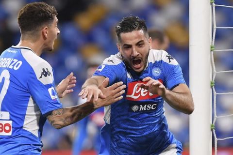Napoli's Konstantinos Manolas, right, celebrates after scoring during a Serie A soccer match between Napoli and Torino at the San Paolo Stadium in Naples, Italy, Saturday, Feb. 29, 2020. (Cafaro/LaPresse via AP)
