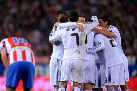 MADRID, SPAIN - MARCH 19: Cristiano Ronaldo celebrates with team mates after Mesut Ozil scored their scored goal during the La Liga match between Atletico Madrid and Real Madrid at Vicente Calderon Stadium on March 19, 2011 in Madrid, Spain.  (Photo by Denis Doyle/Getty Images)