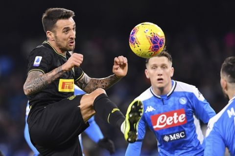 Inter's Matias Vecino, left, and Napoli's Konstantinos Manolas, right, in action during the Serie A soccer match between Napoli and Inter Milan at the San Paolo stadium Naples, Italy, Monday Jan. 6, 2020. (Cafaro/LaPresse via AP)
