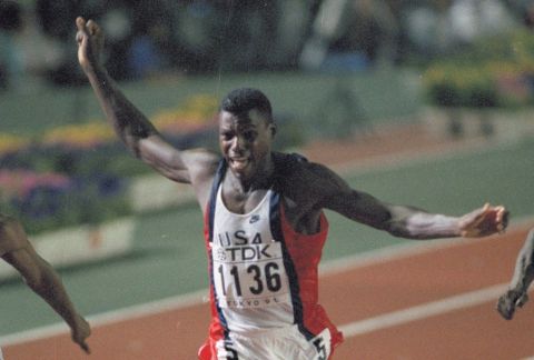 Carl Lewis of the United States crosses the finish line winning the 100-meter final and setting a new world record at the 3rd World Track and Field Championships in Tokyo, Aug. 25, 1991.  Lewis broke the record of fellow American Leroy Burrell who placed second in the race.  (AP Photo/Jack Smith)