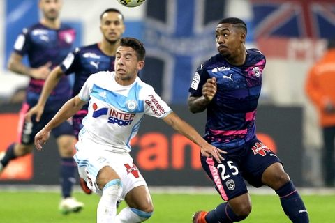 Marseille's midfielder Maxime Lopez, left, in action with Bordeaux's forward Malcom, during the League One soccer match between Marseille and Bordeaux, at the Velodrome stadium, in Marseille, southern France, Sunday, Oct. 30, 2016. (AP Photo/Claude Paris)