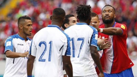 Costa Rica's Kendall Waston, right, confronts Honduras' Alberth Elis (17) and other Honduras players after a rough play, during a World Cup qualifying soccer match at the National Stadium in San Jose, Costa Rica, Saturday, Oct 7, 2017. (AP Photo/Moises Castillo)