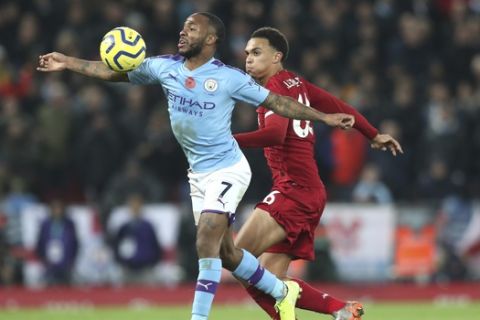 Manchester City's Raheem Sterling, left, challenges for the ball with Liverpool's Dejan Lovren during the English Premier League soccer match between Liverpool and Manchester City at Anfield stadium in Liverpool, England, Sunday, Nov. 10, 2019. (AP Photo/Jon Super)