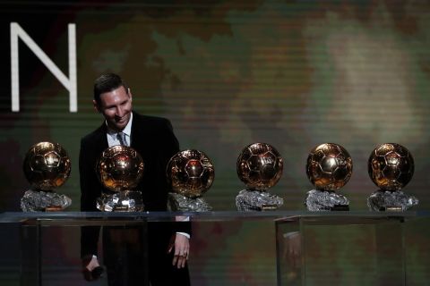FILE - In this Dec. 2, 2019 file photo Barcelona's soccer player Lionel Messi looks at his six Golden Balls during the Golden Ball award ceremony in Paris. Barcelona announced Thursday Aug. 5, 2021 that Lionel Messi will not stay with the club. He is leaving after 17 successful seasons in which he propelled the Catalan club to glory, helping it win numerous domestic and international titles since debuting as a teenager. (AP Photo/Francois Mori, File)