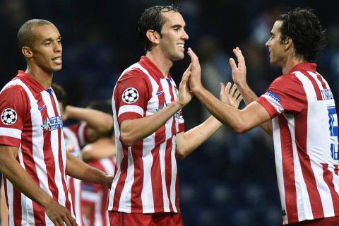 Atletico's defender Diego Godin (C) celebrate with his teammates their  2-1 victory after the Champions League group G football match FC Porto vs Atletico Madrid at Dragao Stadium in Porto on October 1, 2013.  AFP PHOTO/ FRANCISCO LEONGFRANCISCO LEONG/AFP/Getty Images