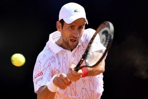 Serbia's Novak Djokovic returns the ball to Italy's Salvatore Caruso, at the Italian Open tennis tournament in Rome, Wednesday, Sept. 16, 2020. (Alfredo Falcone/LaPresse via AP)