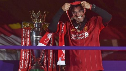 Liverpool's manager Jurgen Klopp puts on his winners medal following the English Premier League soccer match between Liverpool and Chelsea at Anfield Stadium in Liverpool, England, Wednesday, July 22, 2020. Liverpool are champions of the EPL for the season 2019-2020. The trophy is presented at the teams last home game of the season. Liverpool won the match against Chelsea 5-3. (Paul Ellis, Pool via AP)