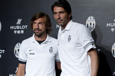 Juventus's goalkeeper Gianluigi Buffon, right, and his teammate Andrea Pirlo pose together in Beijing Tuesday, Aug. 7, 2012. Juventus will play Napoli in their Italian Super Cup at the National Stadium Saturday. (AP Photo/Andy Wong)