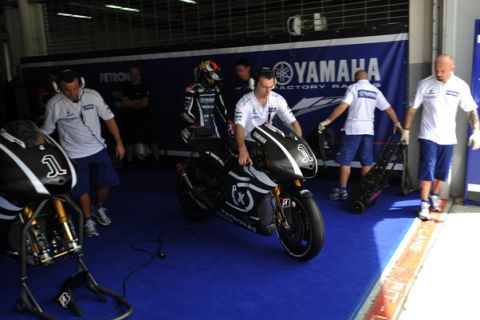 Yamaha crew members take out the bike of Spanish rider Jorge Lorenzo during the MotoGP pre-season test on the Sepang circuit in Sepang near Kuala Lumpur on February 1, 2011. MotoGP world champion Jorge Lorezeno says he is keeping up his guard for this season despite the fact that former world champion Valentino Rossi is sidelined with a shoulder injury.            AFP PHOTO/ Saeed Khan (Photo credit should read SAEED KHAN/AFP/Getty Images)