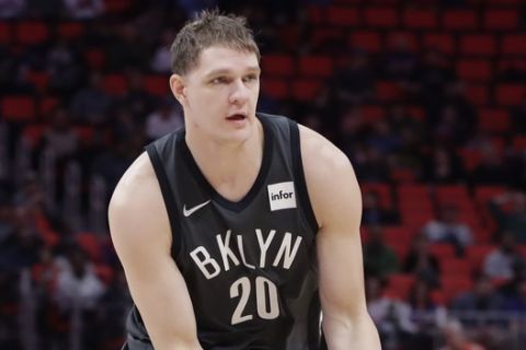 Brooklyn Nets center Timofey Mozgov passes the ball during the first half of an NBA basketball game against the Detroit Pistons, Wednesday, Feb. 7, 2018, in Detroit. (AP Photo/Carlos Osorio)