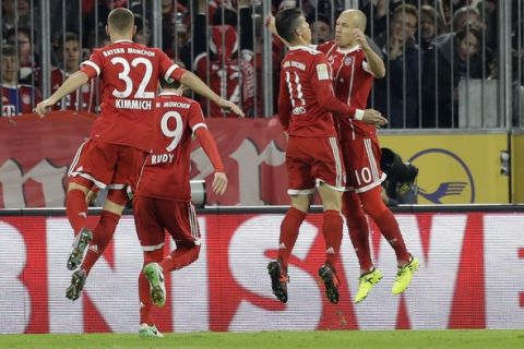 Bayern's Arjen Robben, right, and Bayern's James celebrate after scoring the opening goal during the German Soccer Bundesliga match between FC Bayern Munich and RB Leipzig in Munich, Germany, Saturday, Oct. 28, 2017. (AP Photo/Matthias Schrader)